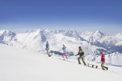a group of people walking up a snow covered mountain at Hôtel Club MMV Le Flaine in Flaine