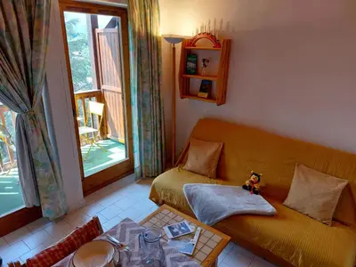 a living room with a couch and a table at Apartment Martagon-2 by Interhome in Saint-Gervais-les-Bains