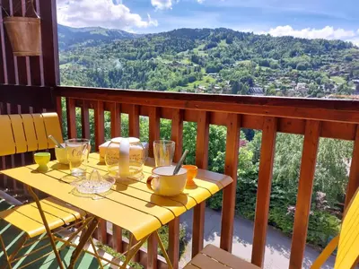 a yellow table with glasses on top of a balcony at Apartment Martagon-2 by Interhome in Saint-Gervais-les-Bains