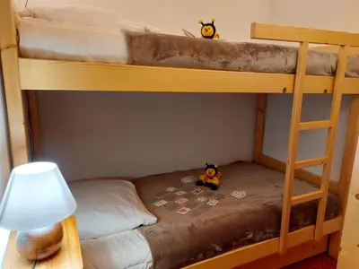 two stuffed animals sitting on the bottom bunk of a bunk bed at Apartment Martagon-2 by Interhome in Saint-Gervais-les-Bains