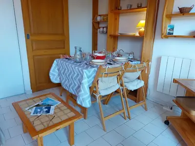 a dining room with a table and a television at Apartment Martagon-2 by Interhome in Saint-Gervais-les-Bains