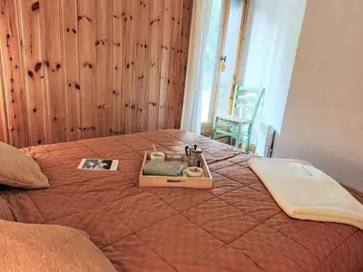 a bed with a stuffed animal sitting on top of it at Apartment Jardins Alpins 8 by Interhome in Saint-Gervais-les-Bains