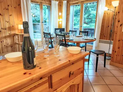 a wine bottle sitting on top of a wooden counter at Apartment Jardins Alpins 8 by Interhome in Saint-Gervais-les-Bains