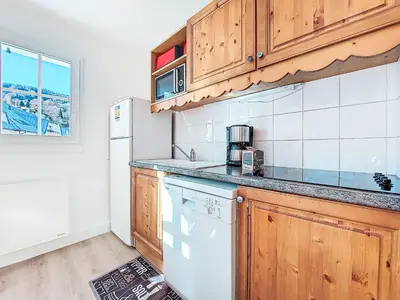 a bedroom with a bed with a blue pillow on it at Apartment Le Grand Panorama 412 by Interhome in Saint-Gervais-les-Bains