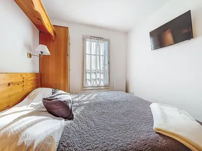 a bedroom with a bed with a stuffed animal on it at Apartment Le Grand Panorama 412 by Interhome in Saint-Gervais-les-Bains
