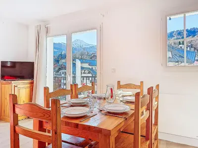 a kitchen with wooden cabinets and a white refrigerator at Apartment Le Grand Panorama 412 by Interhome in Saint-Gervais-les-Bains