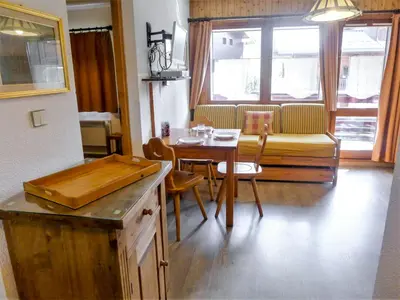 a kitchen and dining room with a table and a couch at Apartment Les Jardins du Mont-Blanc-5 by Interhome in Chamonix-Mont-Blanc