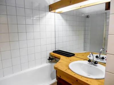 a bathroom with a sink and a bath tub at Apartment Les Jardins du Mont-Blanc-5 by Interhome in Chamonix-Mont-Blanc