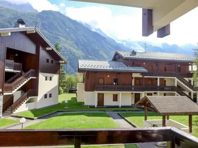 a group of buildings with mountains in the background at Apartment Les Jardins du Mont-Blanc-5 by Interhome in Chamonix-Mont-Blanc