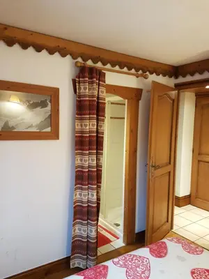a room with a door and a mirror at La Ginabelle Gala in Chamonix-Mont-Blanc