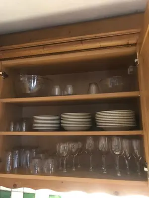 a cabinet filled with plates and cups and dishes at La Ginabelle Gala in Chamonix-Mont-Blanc
