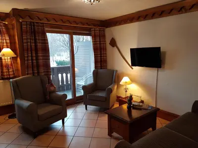 a living room with a couch and two chairs and a television at La Ginabelle Gala in Chamonix-Mont-Blanc