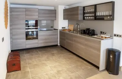 a kitchen with stainless steel cabinets and a trash can at Residence Lesporting Ski – Appartment – АЕ103 in Megève