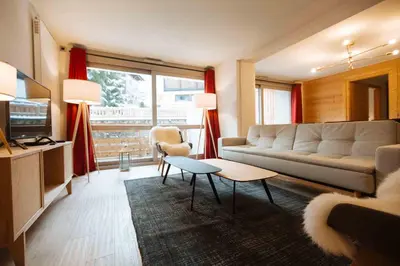 a living room with a couch and a table at Residence Lesporting Ski – Appartment – АЕ103 in Megève