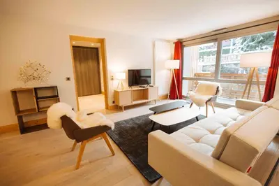 a living room with a couch and chairs and a living room with at Residence Lesporting Ski – Appartment – АЕ103 in Megève