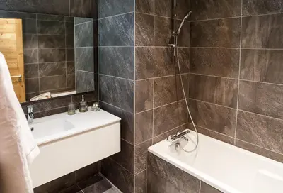 a bathroom with a sink and a tub and a toilet at Fantastic tenement Megève - AE 101 in Megève