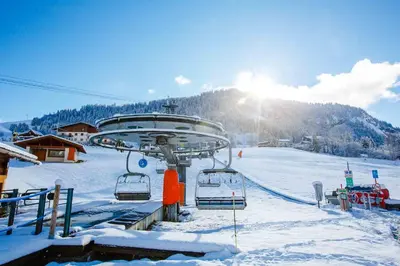 a ski lift in the snow with the sun in the background at Fantastic tenement Megève - AE 101 in Megève