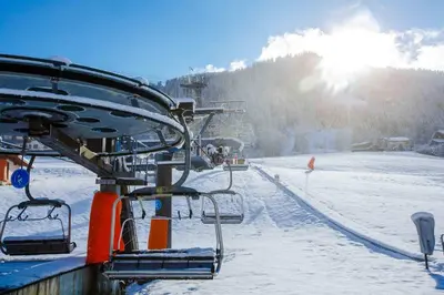 a ski lift with people on it in the snow at Fantastic tenement Megève - AE 101 in Megève