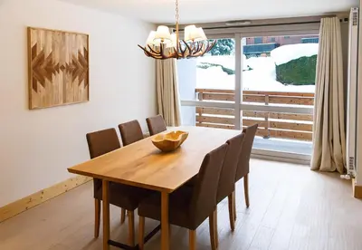 a dining room table with chairs and a large window at Winter Vacances - Megève excellent apartment - AE 301 in Megève