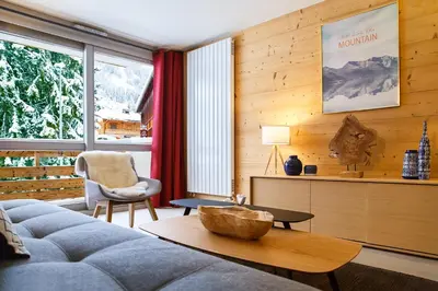 a living room with a couch and a table at Winter Vacances - Megève excellent apartment - AE 301 in Megève