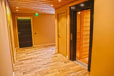an empty hallway with wood floors and doors at Winter Vacances - Megève excellent apartment - AE 301 in Megève