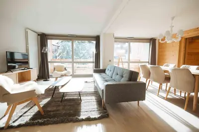 a living room with a couch and a table at Megève Great apartment Lesporting Ski - AE 303 in Megève