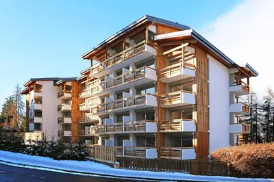an apartment building with balconies on the side of it at Megève Great apartment Lesporting Ski - AE 303 in Megève