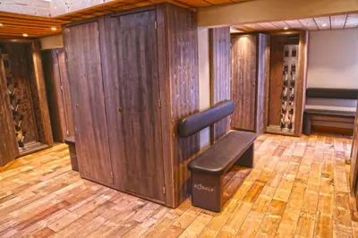 a bench in a wine cellar with wooden walls at Megève Great apartment Lesporting Ski - AE 303 in Megève
