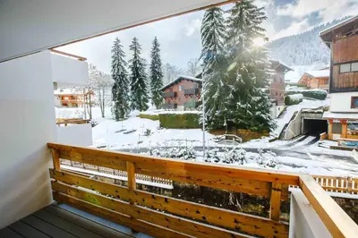 a balcony with a view of a snow covered yard at Megève Great apartment Lesporting Ski - AE 303 in Megève