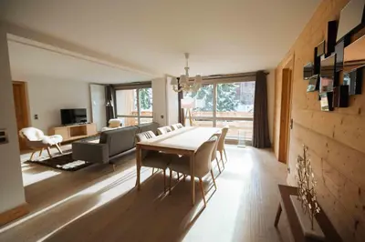 a living room with a dining room table and a couch at Megève Great apartment Lesporting Ski - AE 303 in Megève