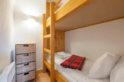 a bedroom with a bunk bed with a ladder at Alpage: Residence Brevent in Les Houches