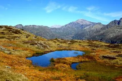 a small pond in the middle of a mountain at Oustalet in Chamonix-Mont-Blanc
