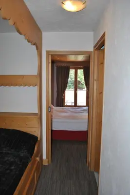 a bedroom with a bed and a window at Oustalet in Chamonix-Mont-Blanc
