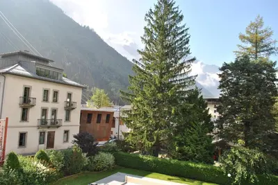 a group of trees in front of a building at Oustalet in Chamonix-Mont-Blanc