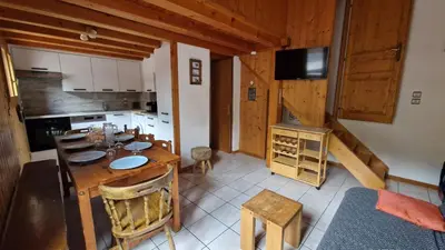 a kitchen and dining room with a table and chairs at Demi-Chalet Le Bief --Prox pistes in Les Carroz d'Araches