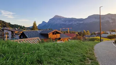 a small town with a mountain in the background at Demi-Chalet Le Bief --Prox pistes in Les Carroz d'Araches