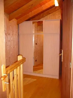 a door leading into a room with wooden floors and ceilings at Demi-Chalet l'Ancolie -- Prox pistes in Les Carroz d'Araches