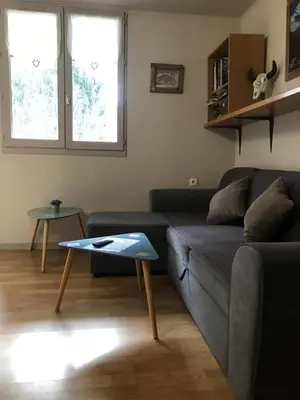 a living room with a couch and a table at Appartement chamonix face au mont blanc in Chamonix-Mont-Blanc
