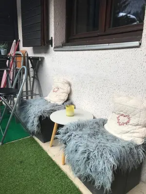 two cushioned chairs and a table on a patio at Appartement chamonix face au mont blanc in Chamonix-Mont-Blanc