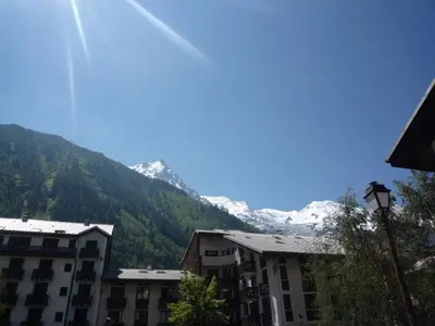 a view of snow capped mountains from a building at Appartement chamonix face au mont blanc in Chamonix-Mont-Blanc