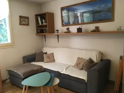 a living room with a couch and a table at Appartement chamonix face au mont blanc in Chamonix-Mont-Blanc