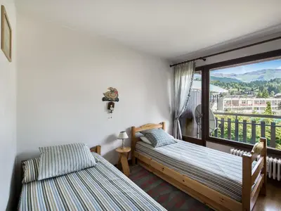a bedroom with two beds and a balcony at Appartement 2 chambres à Megève, proche Palais des Sports - FR-1-453-157 in Megève
