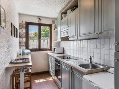 a kitchen with white cabinets and a sink and a window at Appartement 2 chambres à Megève, proche Palais des Sports - FR-1-453-157 in Megève
