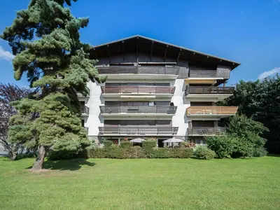 a large building with a tree in front of it at Appartement 2 chambres à Megève, proche Palais des Sports - FR-1-453-157 in Megève