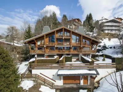 a large wooden house in the snow at Appartement 3 pièces avec parking à Megève Rochebrune - FR-1-453-166 in Megève