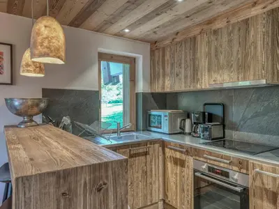 a kitchen with wooden cabinets and a sink at Appartement 3 pièces avec parking à Megève Rochebrune - FR-1-453-166 in Megève