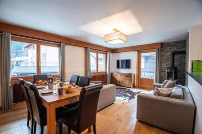 a living room with a table and a couch at Mintaka Apartment - Chamonix in Chamonix-Mont-Blanc