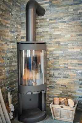 a fireplace in a room with a brick wall at Mintaka Apartment - Chamonix in Chamonix-Mont-Blanc