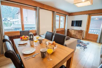 a dining room table with a bowl of food on it at Mintaka Apartment - Chamonix in Chamonix-Mont-Blanc