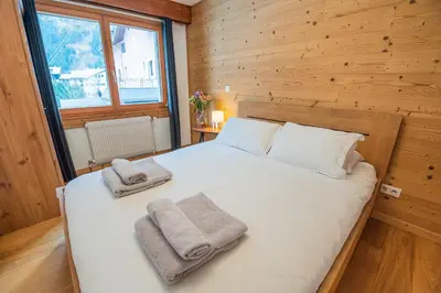 a bedroom with a bed with towels on it at Mintaka Apartment - Chamonix in Chamonix-Mont-Blanc